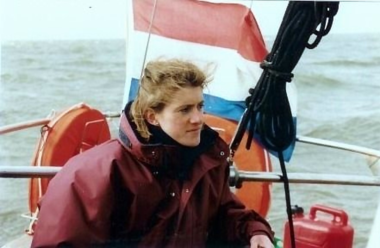 A. van de Nadort in the cockpit under way, Dutch ensign behind her